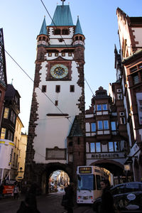 Clock tower in city against clear sky