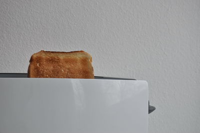 Close-up of breakfast on table against wall