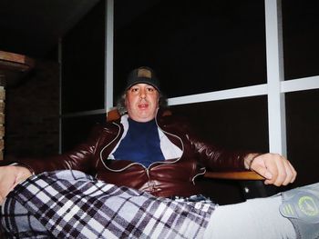 Portrait of senior man sitting on sofa at home