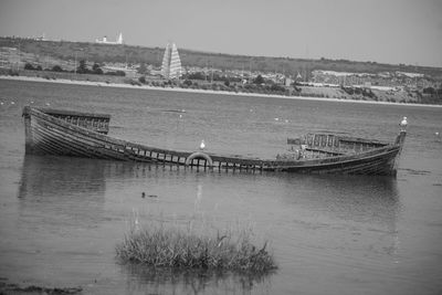 Boats moored in river