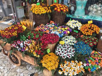 Various flowers on display at market stall