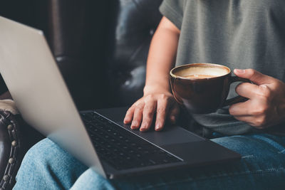 Midsection of coffee cup on table