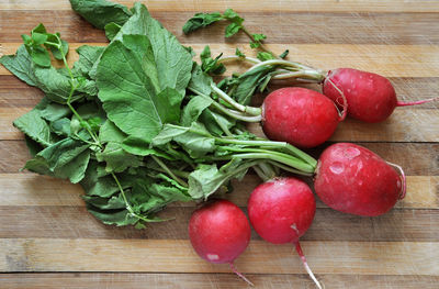 Bunch of fresh radishes on wooden table