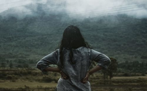 Rear view of woman standing outdoors