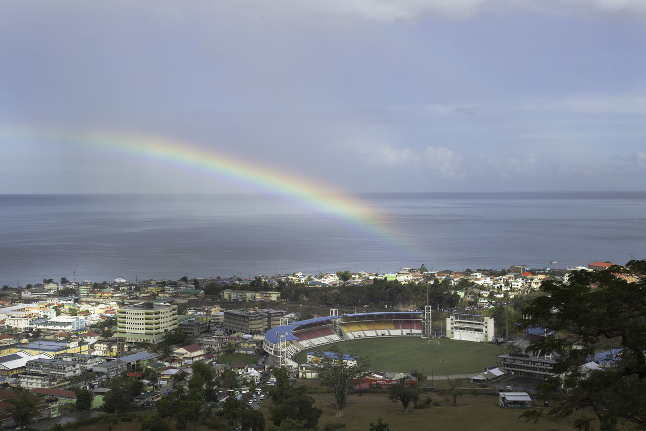 SCENIC VIEW OF RAINBOW OVER CITY BUILDINGS