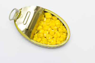 High angle view of yellow eggs on white background