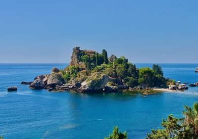 Scenic view of sea against clear blue sky