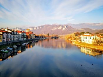 Scenic view of lake by buildings against sky