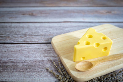 High angle view of yellow and cutting board on table