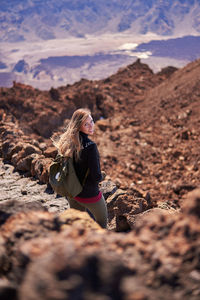 Portrait of woman standing on rock