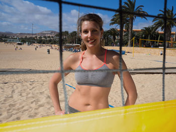 Portrait of young woman sitting on beach