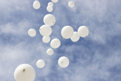 Low angle view of balloons against sky