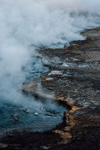 High angle view of steam emitting from hot spring