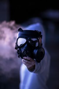 Close-up of man holding gas mask