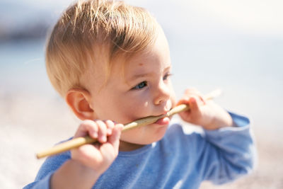 Close-up portrait of boy holding baby