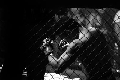 Close-up of man practicing in boxing rink