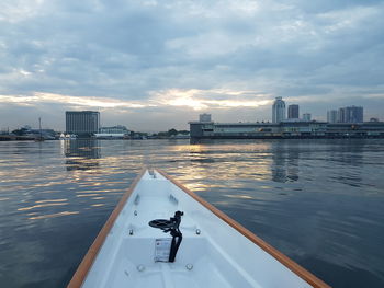 Scenic view of river by buildings against sky