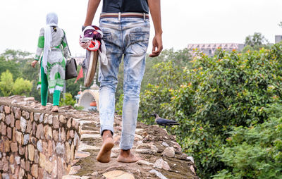 Low section of man standing on wall