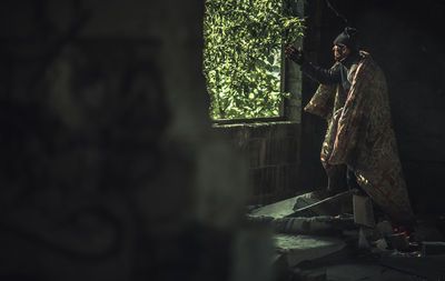 Man standing at temple against building