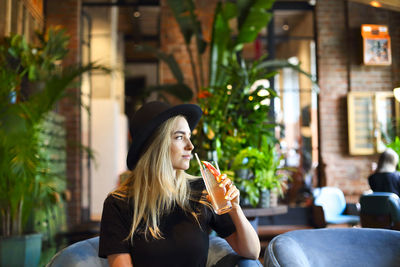 Young woman sitting in restaurant