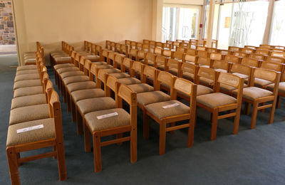 Empty chairs and tables in row