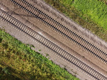 High angle view of railroad tracks on field