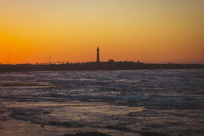 Scenic view of sea against orange sky