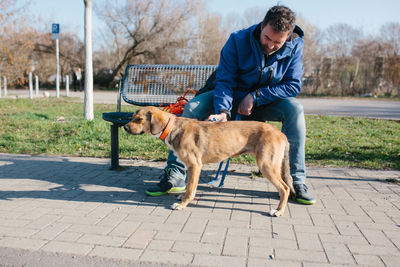 Man with dog on footpath