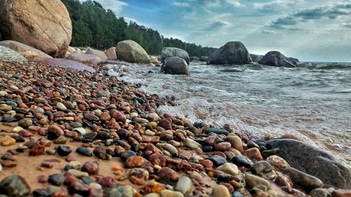 Rocks on beach against sky