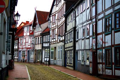 Empty street amidst buildings in city