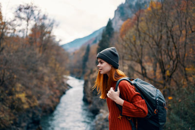 Young woman standing in park during autumn