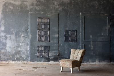 Empty chair in abandoned building