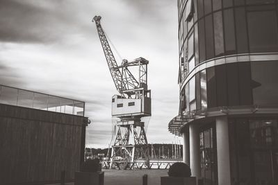 Low angle view of modern building against cloudy sky