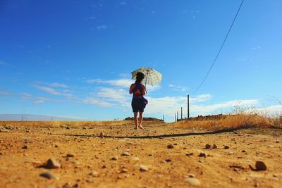 Full length of woman standing on landscape