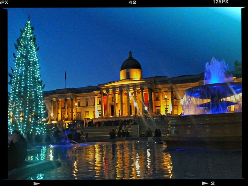 building exterior, illuminated, architecture, built structure, night, blue, water, reflection, city, transfer print, street, incidental people, auto post production filter, sky, clear sky, city life, street light, lighting equipment, building, car