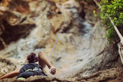 Low angle view of female rock climber