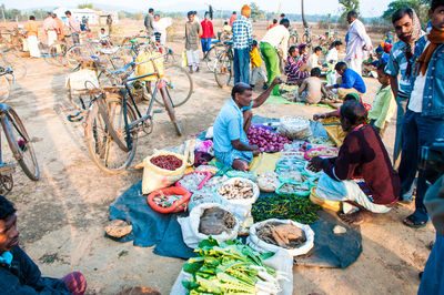 High angle view of people sitting at village market stall