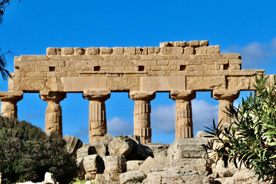 Old ruins of temple against blue sky