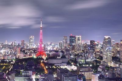 Illuminated cityscape against sky at night