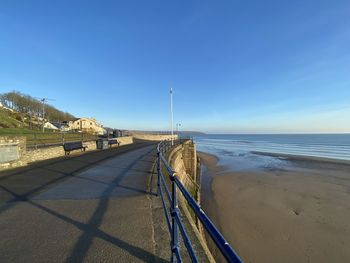Scenic view of beach against clear blue sky