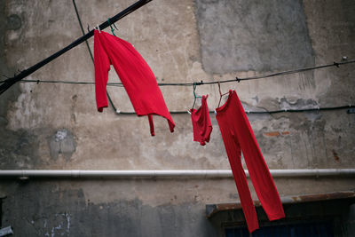 Low angle view of clothes drying on clothesline against wall