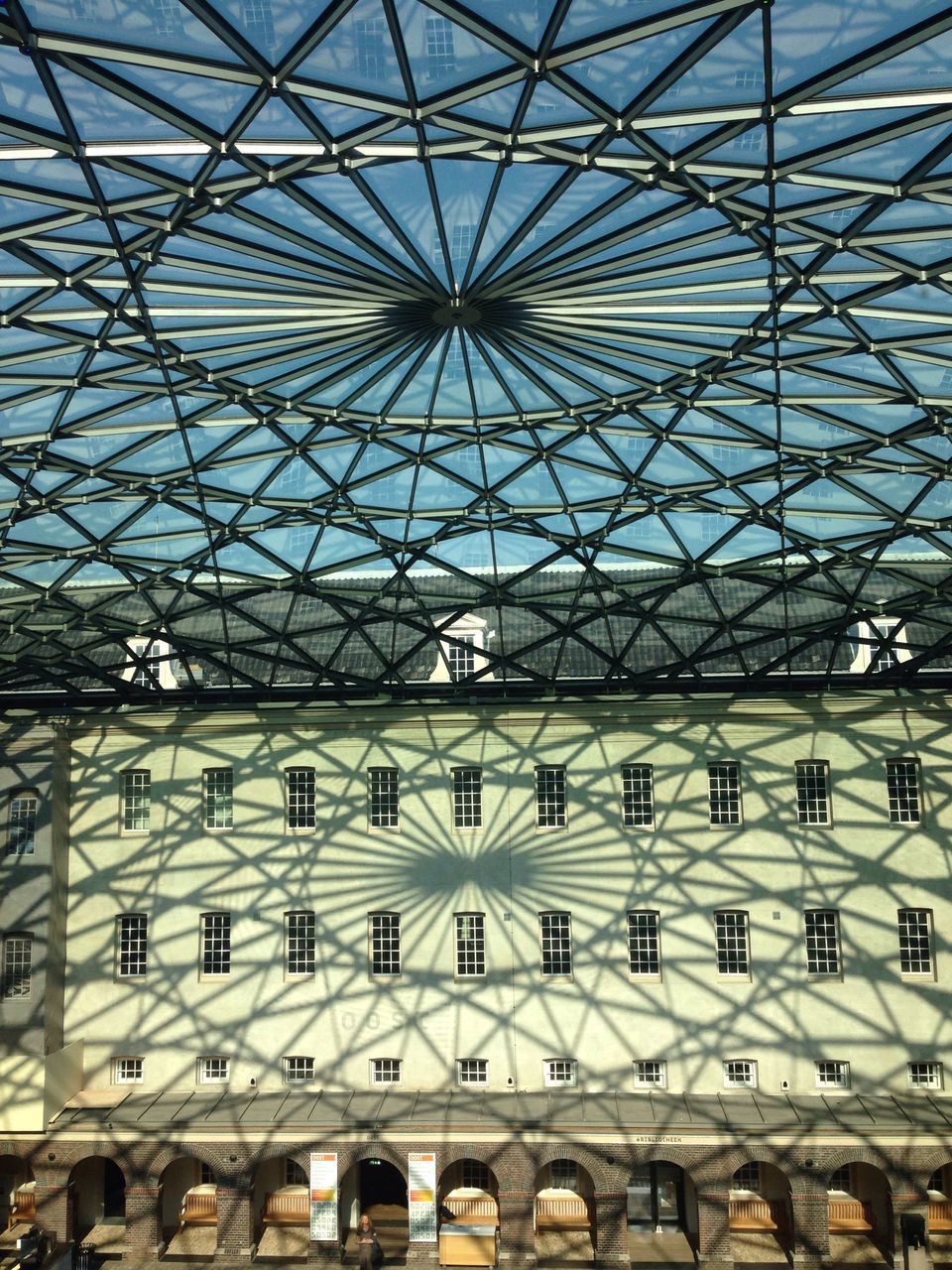 ceiling, indoors, architecture, built structure, low angle view, pattern, full frame, architectural feature, backgrounds, skylight, design, glass - material, repetition, arch, window, interior, no people, day, in a row, dome