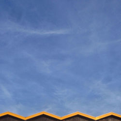 High section of built structure against blue sky