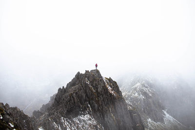 Man standing on snowcapped mountain