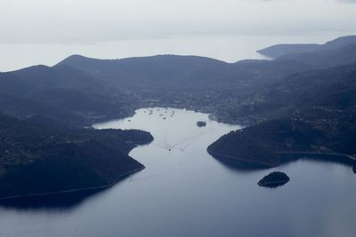 Scenic view of lake and mountains against sky