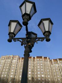 Low angle view of lamp post against clear blue sky