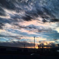 Road against cloudy sky at sunset