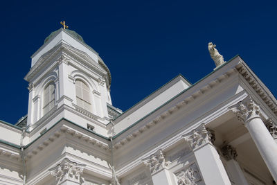 Low angle view of ornate building against clear blue sky