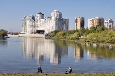 View of lake and buildings in city