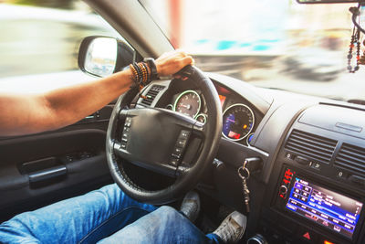 Low section of man driving car